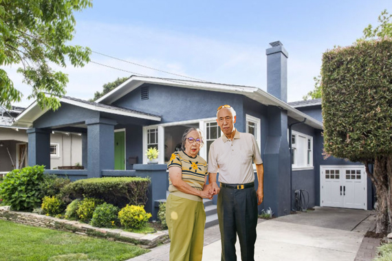 Photo of an older couple in front of an Arts and Crafts bungalow